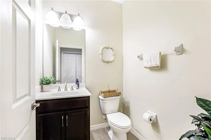 Bathroom with tile patterned floors, vanity, and toilet