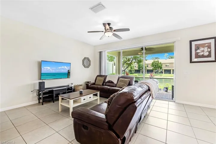 Tiled living room featuring ceiling fan
