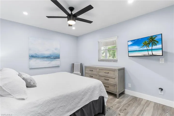 Bedroom with a ceiling fan, light wood-style flooring, recessed lighting, and baseboards