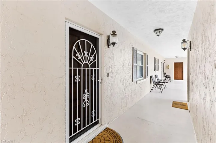 Doorway to property featuring stucco siding