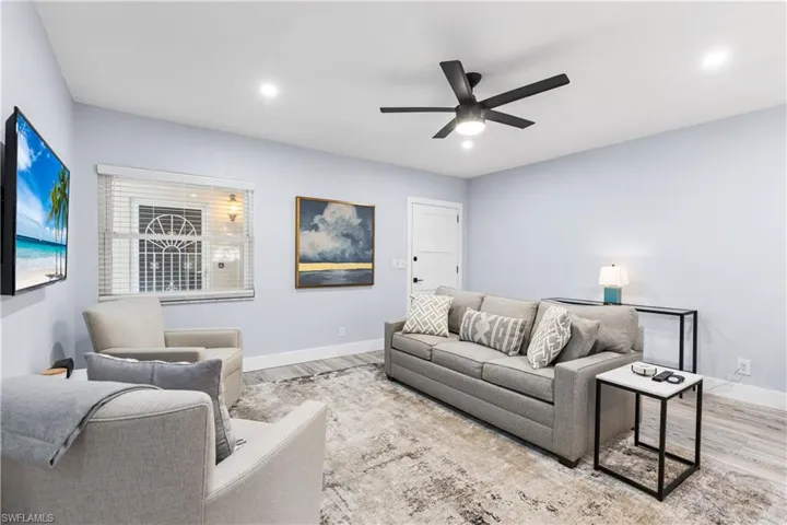 Living area with recessed lighting, baseboards, ceiling fan, and wood finished floors