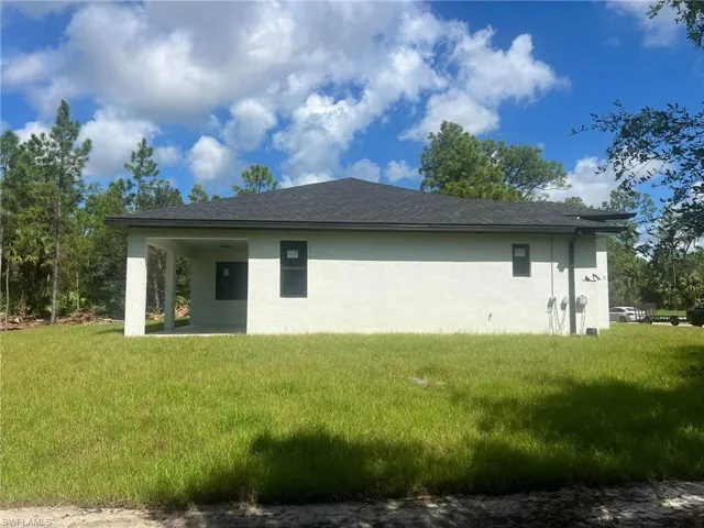 View of property exterior with a yard