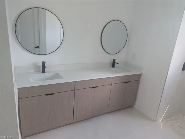 Bathroom with tile patterned flooring and vanity