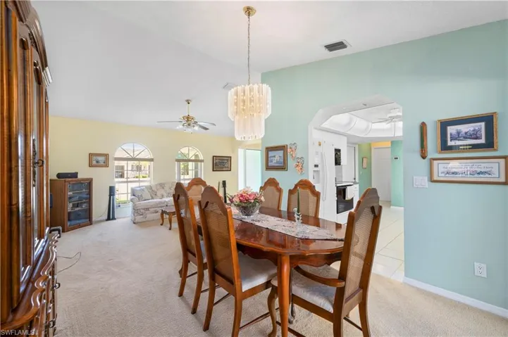 Family Room with light colored carpet, lofted ceiling, and ceiling fan
