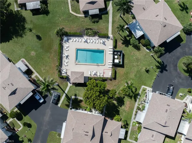 Aerial view of property and surrounding area featuring nearby suburban area
