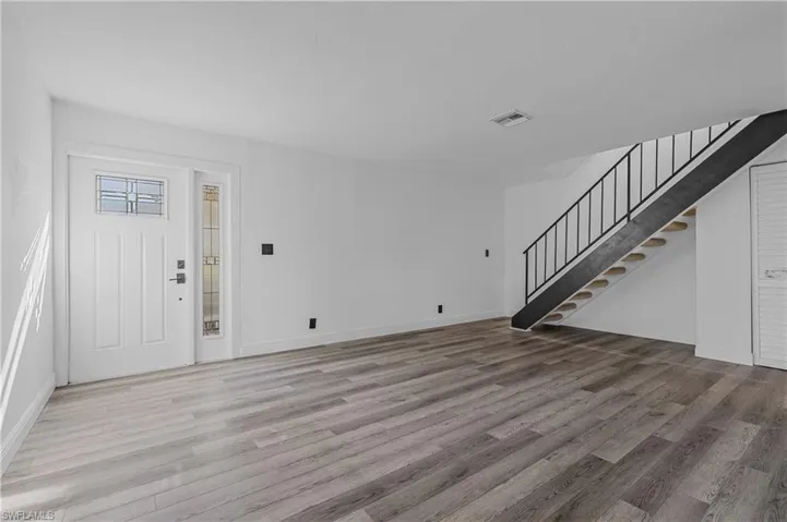 Entrance foyer with light wood finished floors and stairway