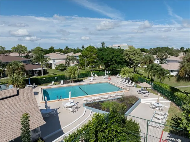 Community pool with a patio and a residential view