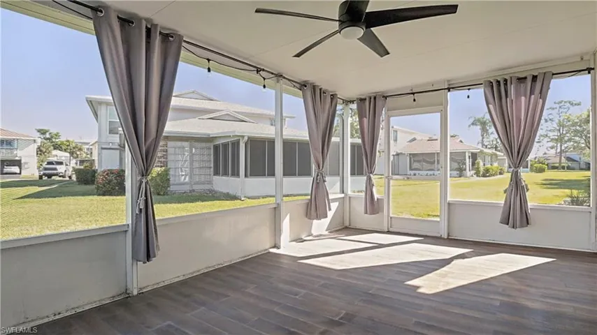 Unfurnished sunroom with a ceiling fan