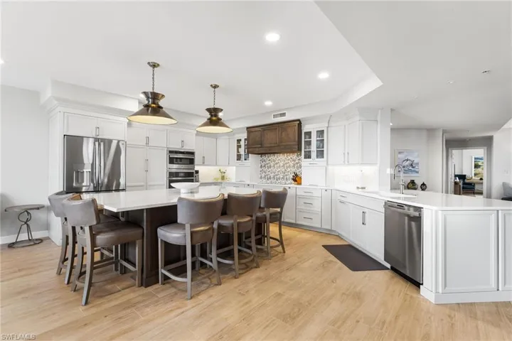 Beautful backsplash, stainless steel appliances, custom cabinetry, underlighting.