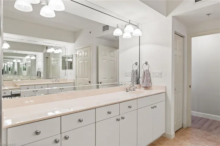 Separate vanities in the primary bathroom.  Private water closet.