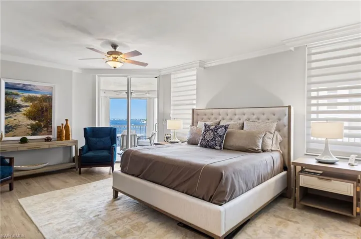 Your oversized primary bedroom has access to your wrap around lanai with stunning river views! Custom crown molding with Hunter Douglas blinds. Tile flooring.