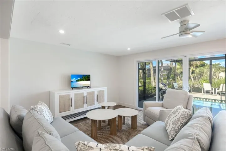 Living area with recessed lighting and ceiling fan