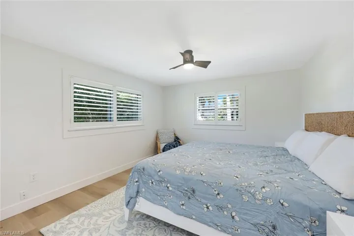 Bedroom with wood finished floors and ceiling fan