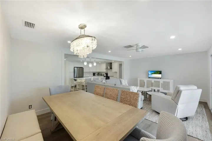 Dining space featuring a chandelier, recessed lighting, wood finished floors, and a ceiling fan