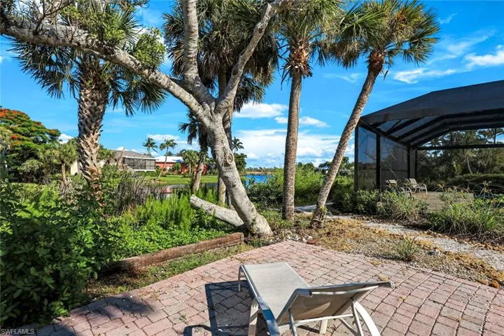 View of patio featuring a water view and a lanai