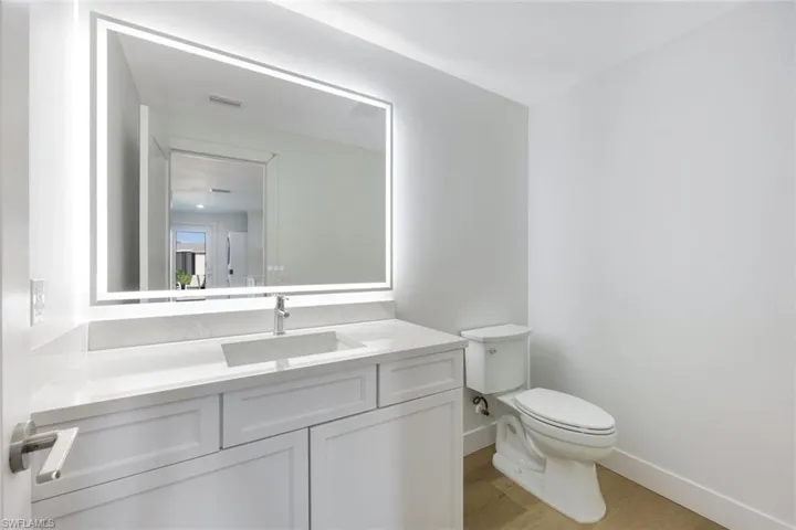 Bathroom with wood finished floors and vanity