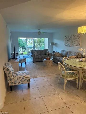 Tiled living room featuring ceiling fan