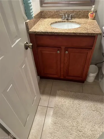 Bathroom featuring tile patterned floors, vanity, and toilet