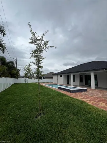 View of yard with a fenced in pool and a patio