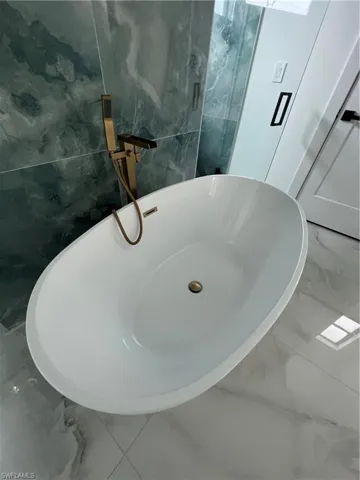 Bathroom with tile walls and tile floors