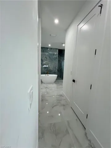 Hall featuring light tile floors