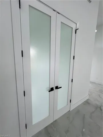 Details featuring tile floors and french doors