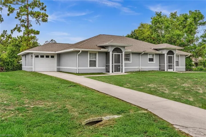 Single-story residence featuring a gray exterior, white trim, and a brown shingle roof
