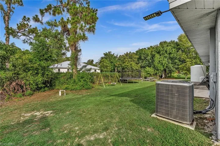 Expansive green lawn with mature trees, offering ample outdoor space