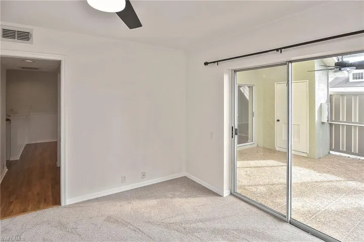 Empty room with carpet and ceiling fan
