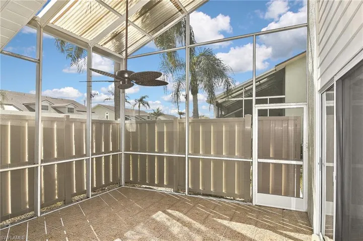 Unfurnished sunroom featuring lofted ceiling and ceiling fan