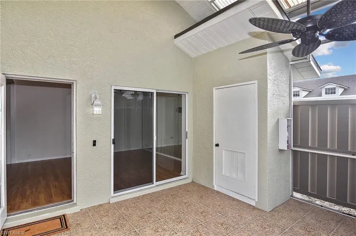 View of exterior entry with ceiling fan