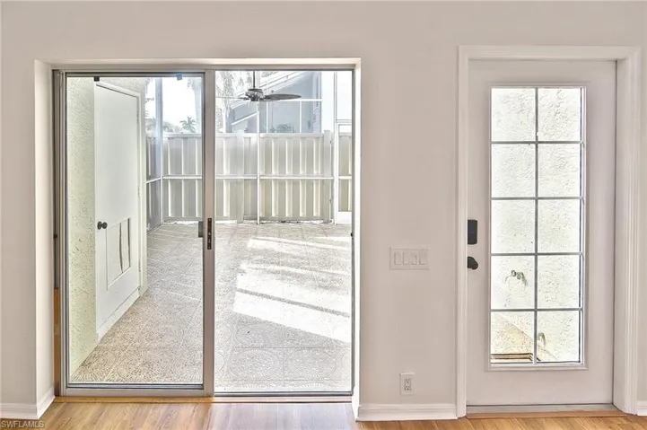 Doorway featuring hardwood / wood-style flooring and a healthy amount of sunlight