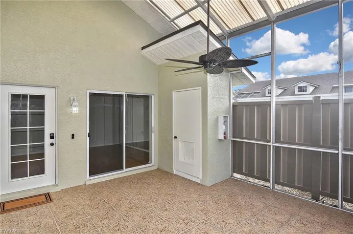 Unfurnished sunroom with ceiling fan
