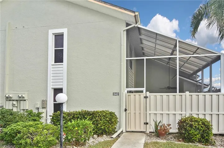 View of side of property featuring glass enclosure