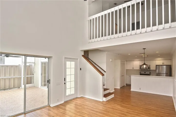 Entrance foyer with a towering ceiling and light hardwood / wood-style flooring