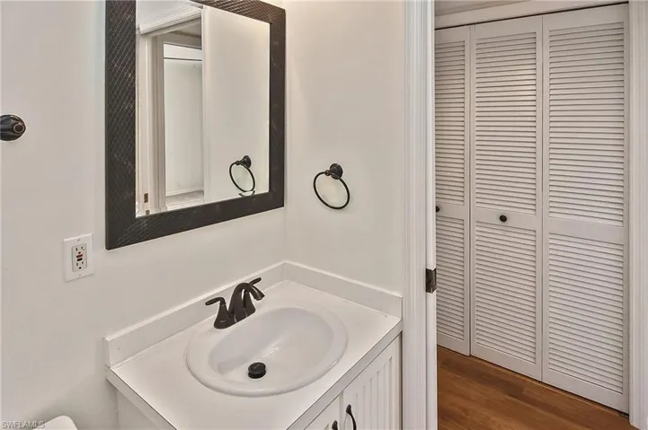 Bathroom featuring vanity and hardwood / wood-style floors