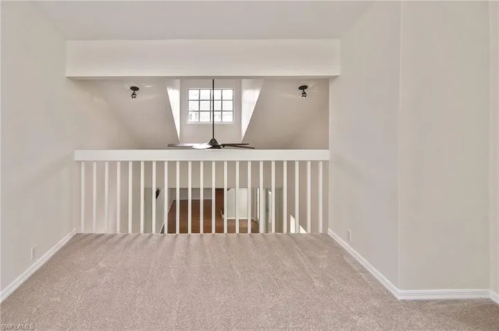 Bonus room featuring carpet, vaulted ceiling, and ceiling fan