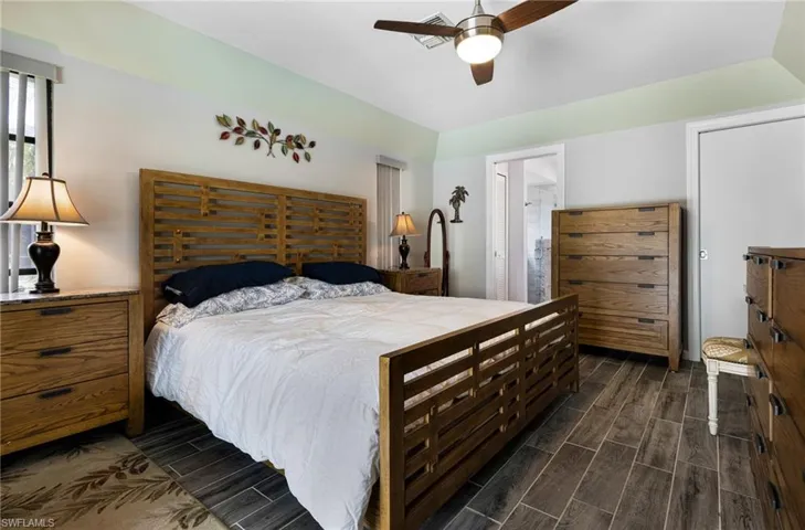 Bedroom featuring ceiling fan and dark hardwood / wood-style flooring