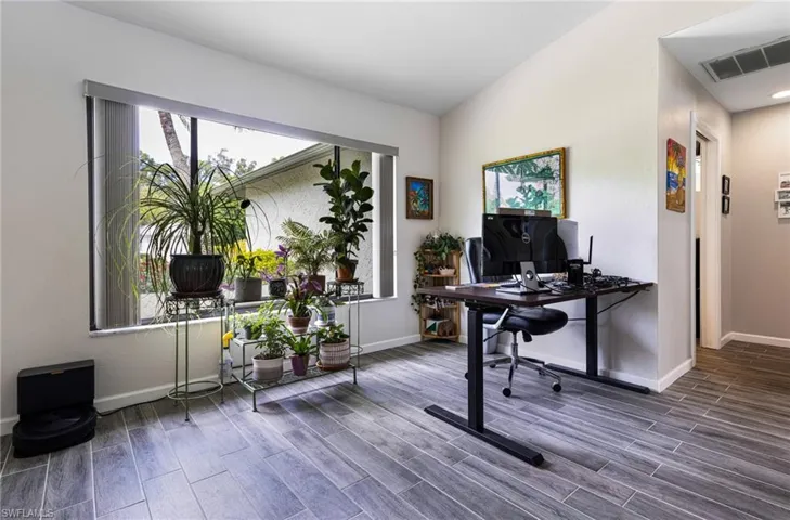 Office area featuring lofted ceiling and hardwood / wood-style flooring