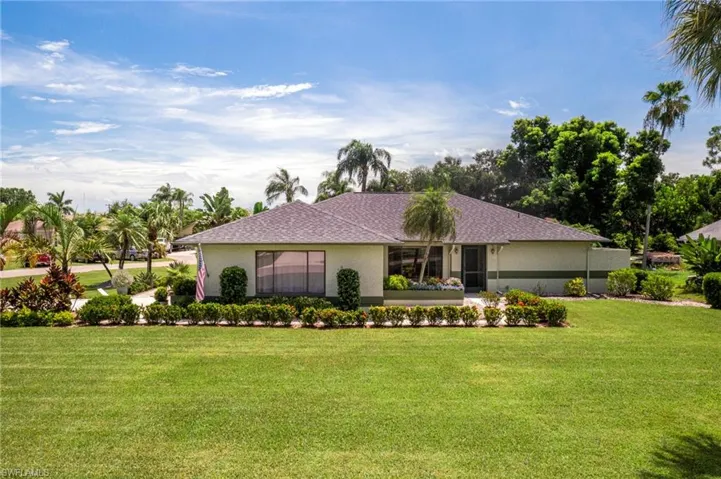 Single story home with a front lawn