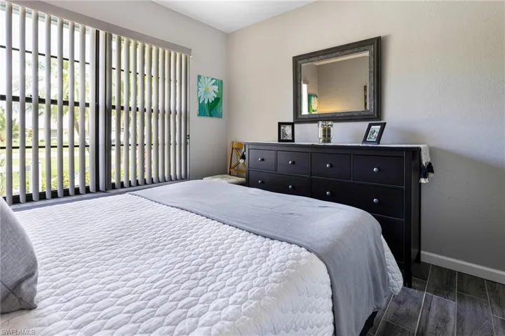 Bedroom featuring hardwood / wood-style floors and multiple windows