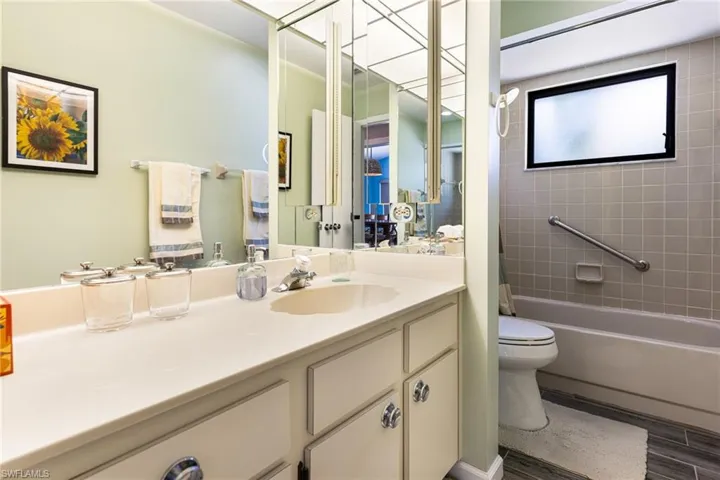 Full bathroom featuring vanity, tiled shower / bath, and toilet