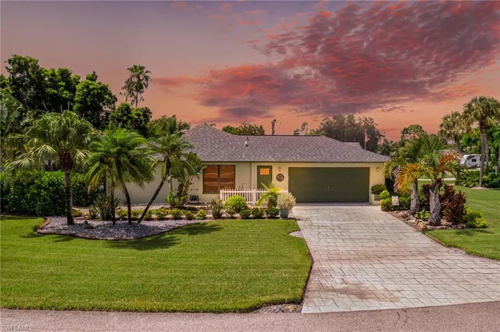 Ranch-style home with a yard and a garage