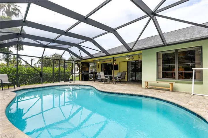 View of pool with a lanai and a patio area