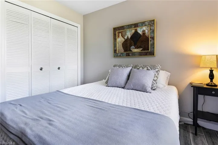 Bedroom featuring dark hardwood / wood-style flooring and a closet