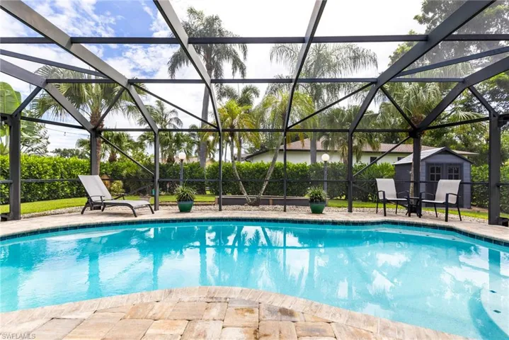 View of pool featuring glass enclosure