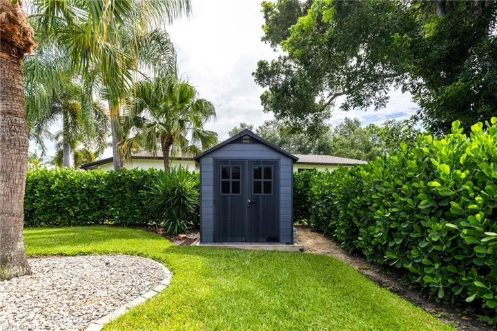 View of outdoor structure with a yard