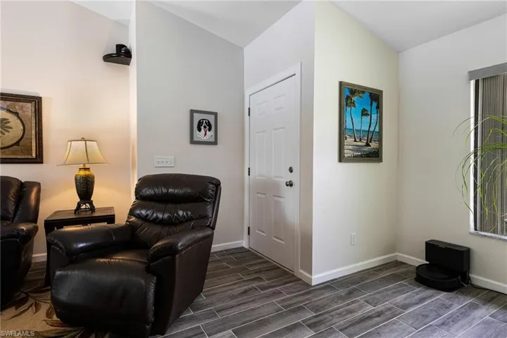 Living area with dark wood-type flooring