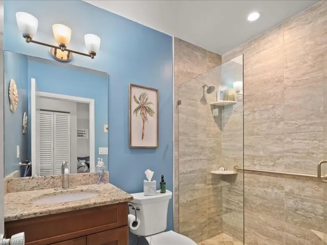 Full bath with walk in shower and vanity