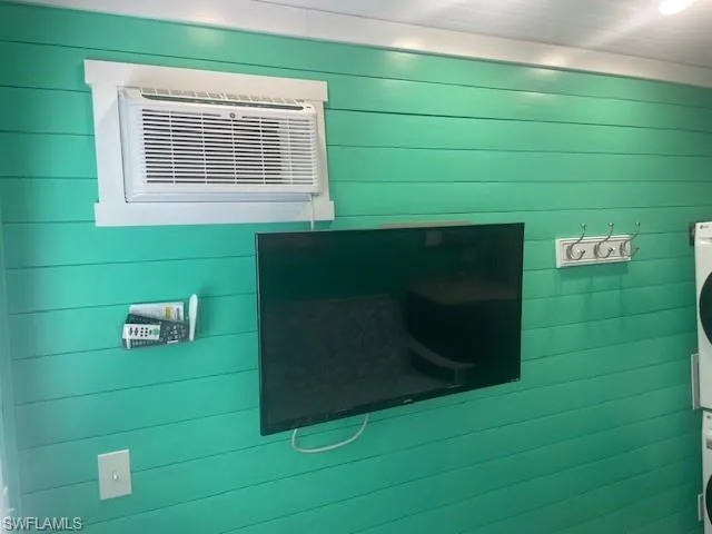Details with wood walls and a wall mounted air conditioner